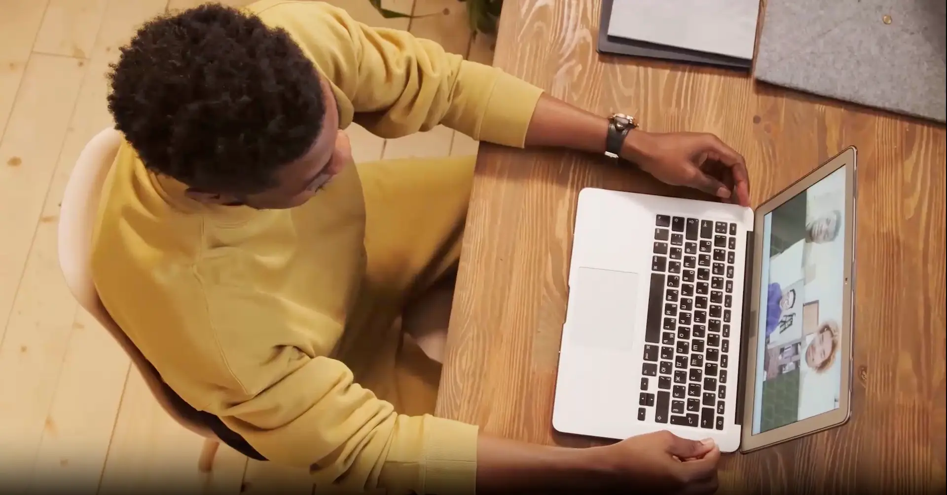 Student on laptop at table in online class.