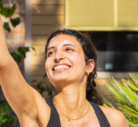 girl stretching to the sky and smiling